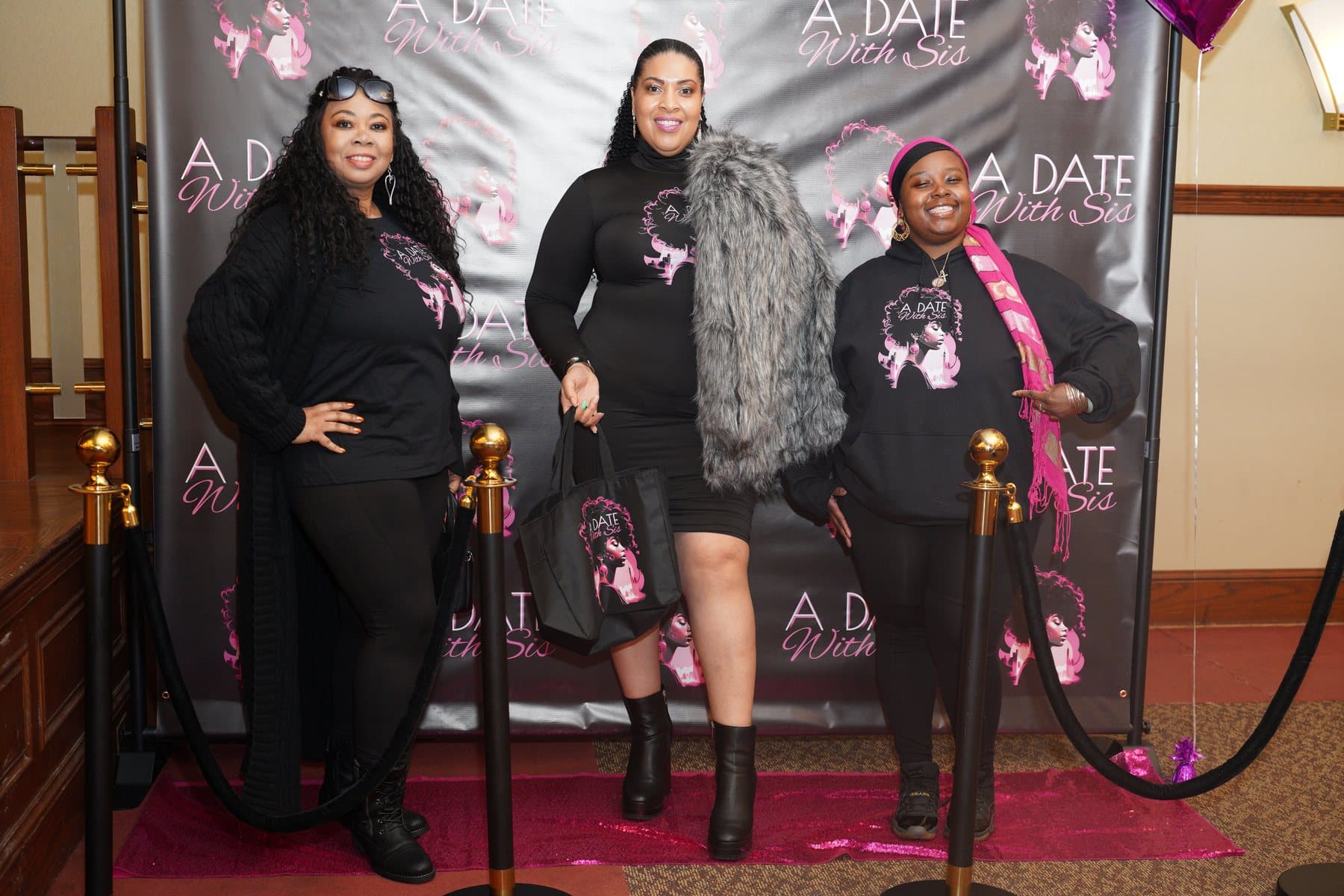 Women posing together at the A Date With Sis backdrop